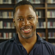 Smiling man with dark hair and a salt-and-pepper goatee